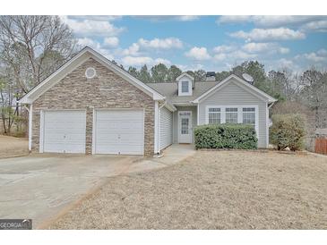 Charming single-Gathering home featuring a two-car garage and stone accents with manicured landscaping at 131 Meadowbrook Ln, Grantville, GA 30220