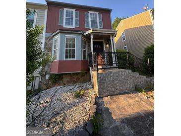 Charming two-story home with stone accents and a well-maintained front yard and porch at 6444 Charter Way, Lithonia, GA 30058