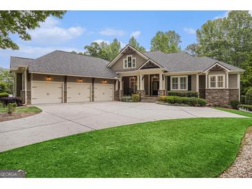 A charming exterior featuring a three car garage and stone and wood accents at 115 Edgewood Pkwy, Fayetteville, GA 30215