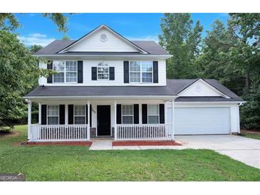 Charming two-story home with a welcoming front porch, black shutters, and a well-maintained lawn at 145 Tara Way, Covington, GA 30016
