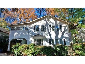 Charming two-story home with lush landscaping and mature trees creating a peaceful setting at 32 Highland Ne Dr, Atlanta, GA 30305