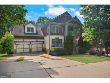 Charming home with a three-car garage, well-manicured lawn, and inviting covered front porch at 2548 Kickerillo Se Way, Atlanta, GA 30316