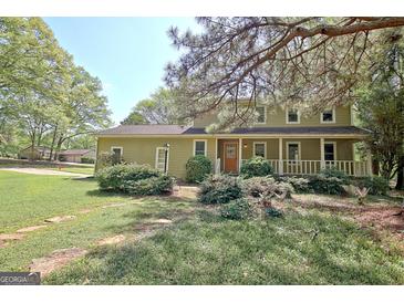 Charming two-story home with a welcoming front porch and beautifully landscaped front yard at 401 Waterwood Bnd, Peachtree City, GA 30269