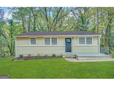 Charming single-story home with a brick foundation and a well-manicured lawn at 3332 Ruby H Harper Se Blvd, Atlanta, GA 30354