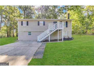 Inviting two-story home with a well-maintained lawn, complemented by a stairway leading to the front door at 3995 Willowbrook Dr, Douglasville, GA 30135