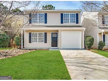 Charming two-story home with a well-manicured lawn and a one car garage at 263 Coral Cir, Mcdonough, GA 30253