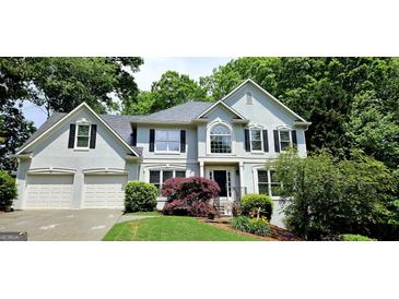 Charming two-story home with manicured lawn, a two-car garage and inviting front entrance at 1008 Stonekirk Trce, Lawrenceville, GA 30043