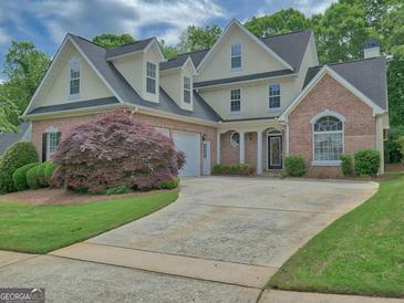 Beautiful two story home with manicured lawn, brick accents, and a two car garage at 187 Eagles Club Dr, Stockbridge, GA 30281