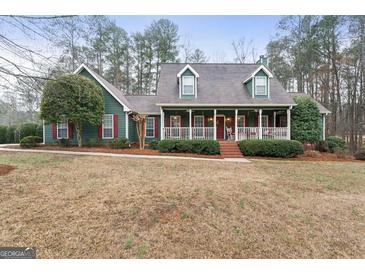 Charming two-story home with a welcoming front porch and mature landscaping at 4186 Highway 138 Sw, Stockbridge, GA 30281