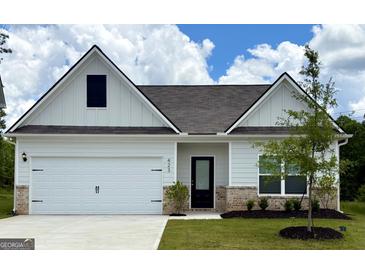 Charming single-story home with a two-car garage and well-manicured lawn at 423 Prescott Way, Villa Rica, GA 30180