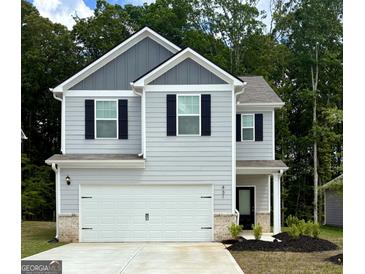 Charming two-story home featuring a gray siding, black shutters, and a spacious white garage door at 431 Prescott Way, Villa Rica, GA 30180