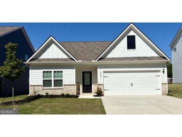 Charming home exterior with white siding, two-car garage, manicured lawn, and black front door with prominent house number at 442 Prescott Way, Villa Rica, GA 30180