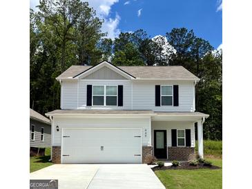 Charming two-story home featuring a spacious garage, black accents, and a well-manicured lawn at 449 Prescott Way, Villa Rica, GA 30180