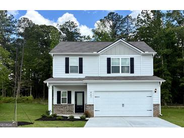 Charming two-story home features a two-car garage, black shutters, and a well-manicured lawn at 467 Prescott Way, Villa Rica, GA 30180