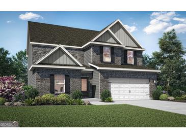 Charming two-story home featuring a two-car garage, gray brick, and a well-manicured front lawn at 425 Prescott Way, Villa Rica, GA 30180