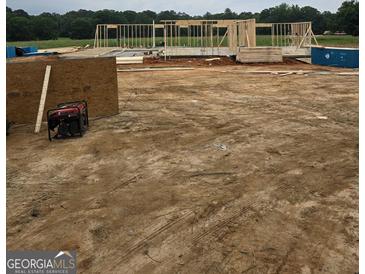 A home under construction showing its wooden frame with a generator and construction material visible at 3261 Broadnax Mill Rd # 2, Loganville, GA 30052
