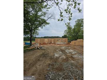 New construction featuring wood frame of house, lumber, and visible construction site at 3251 Broadnax Mill Rd # 3, Loganville, GA 30052