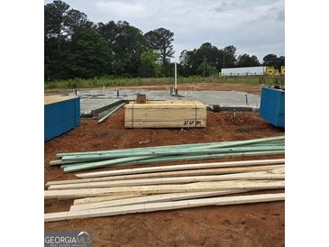 A construction site shows the foundation and framing materials for a new home build at 3245 Broadnax Mill Rd # 7, Loganville, GA 30052