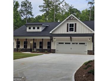 Stunning two-story home with a spacious two-car garage and a well-manicured front yard at 6093 Wayfarer Dr, Villa Rica, GA 30180