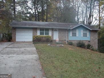 Charming single-story home featuring a brick facade, attached garage, and a well-manicured front lawn at 1320 Labelle St, Jonesboro, GA 30238