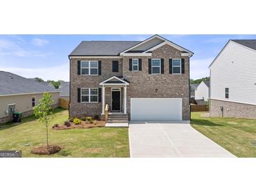 Beautiful two-story brick home with a well-manicured lawn and an attached two-car garage at 604 Whitman Ln # 27, Stockbridge, GA 30281