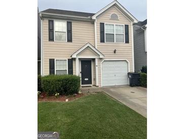 Charming two-story home with attached garage and well-maintained lawn at 45 Fieldview Ln, Covington, GA 30016
