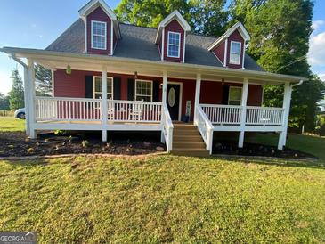 Charming red home with a welcoming front porch and well-maintained lawn at 800 Attaway Rd, Bowdon, GA 30108