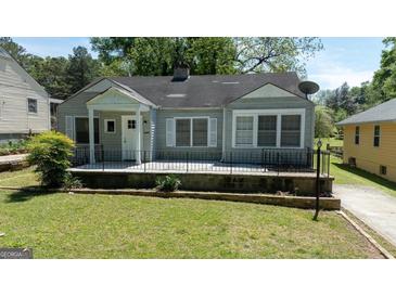 Charming single-story home with large front porch and well-maintained lawn at 1774 Campbellton Rd, Atlanta, GA 30311