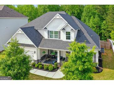Charming home with a covered porch, swing, landscaped garden, and elegant architectural details at 19 Mediterranean Ave # 506, Sharpsburg, GA 30277