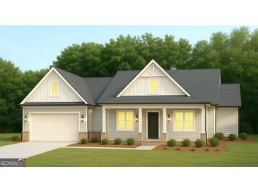 Charming single-story home featuring light-colored siding, a two-car garage, and a welcoming front porch with a dark front door at 6169 Pinewood Se Dr, Covington, GA 30014