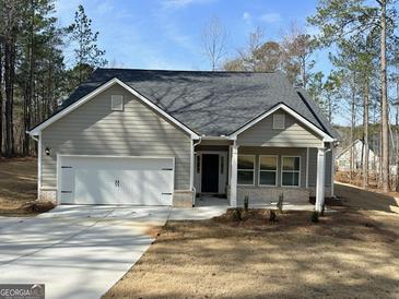 Charming single-story home with a gray exterior, attached garage and manicured lawn at 5096 Cumberland Ct # 96, Villa Rica, GA 30180