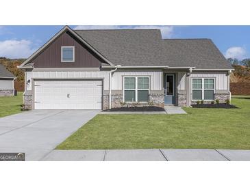 Charming single-Gathering home features a well-manicured lawn, two-car garage, and inviting entryway at 539 Cantrell Drive, Dallas, GA 30157