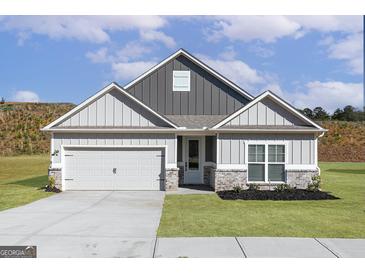 Charming single-Gathering home with gray siding, a two-car garage, and well-manicured lawn at 601 Cantrell Drive, Dallas, GA 30157