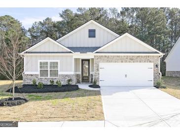 Charming single-story home with a two-car garage, neutral paint, and brick accents at 3744 Saddle Bag Ct, Dacula, GA 30019
