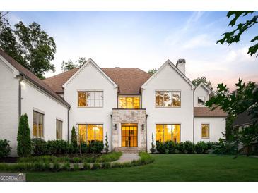 Stunning two-story home with a manicured lawn and a stone accent entryway at 490 Mount Paran Rd, Atlanta, GA 30327