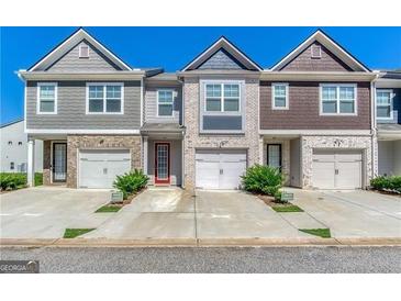 Attractive townhomes featuring single-car garages, private driveways, and colorful facades at 5009 Longview Walk, Decatur, GA 30035