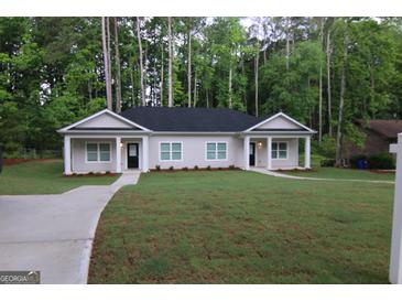 Charming single-story home with a well-manicured lawn and inviting entryway nestled amongst mature trees at 320 Sharon Dr # A & B, Fayetteville, GA 30214