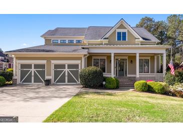 Charming two-story home featuring a welcoming front porch, three-car garage and manicured landscaping at 237 Highcrest Dr, Acworth, GA 30101