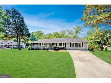 Charming brick home with a well-maintained lawn and classic architectural details, perfect for suburban living at 5327 David Se Cir, Covington, GA 30014