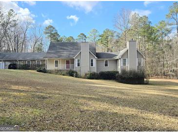 Charming home featuring a covered front porch, complemented by mature trees and landscaping at 110 Kari Glen Way, Fayetteville, GA 30215