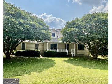 Charming single-Gathering home with a well-manicured lawn and mature trees, creating an inviting curb appeal at 105 Birch Creek Cir, Mcdonough, GA 30253