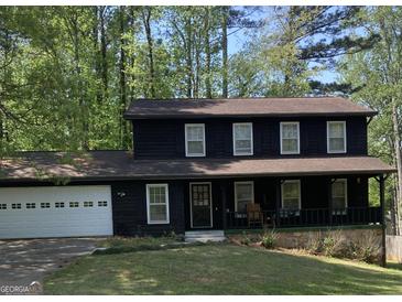 Charming two-story home with a welcoming front porch and a spacious two-car garage at 300 Martingale Dr, Peachtree City, GA 30269
