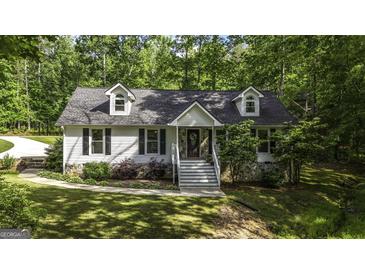 Charming home with stone accents, landscaped yard, and inviting front porch at 3180 Sweetbriar Dr, Villa Rica, GA 30180