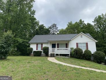 Charming one-story home featuring a covered front porch and red shutters at 50 Glenmore Dr, Kingston, GA 30145