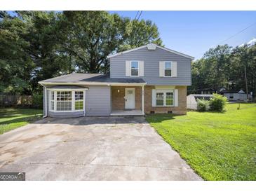 Charming home showcasing a two-story layout and welcoming front yard at 6369 Havenridge Dr, Riverdale, GA 30274