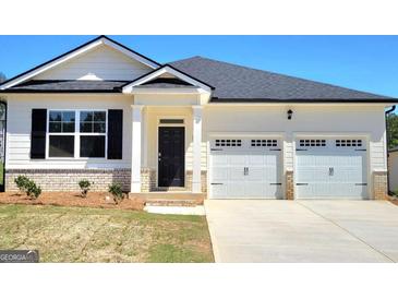 Charming single-Gathering home featuring a 2-car garage, neutral paint, and a welcoming front entrance at 346 Friendship Oak Way, Hampton, GA 30228