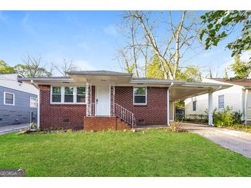Charming brick home featuring a well-maintained lawn and covered parking at 338 Mount Zion Rd, Hapeville, GA 30354