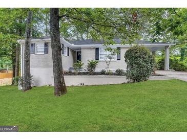 Charming single-story home with light colored brick and a well-maintained front lawn at 1814 Mary Lou Se Ln, Atlanta, GA 30316