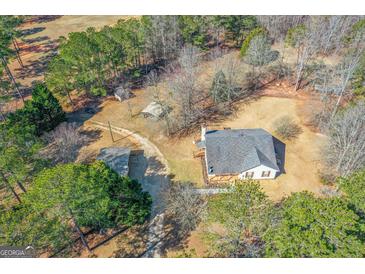 Beautiful home on large lot with mature trees and outbuildings offering privacy and space to enjoy outdoor activities at 3725 Concord Rd, Newborn, GA 30056