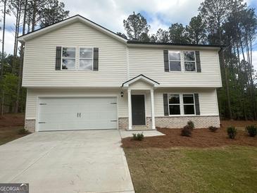 Charming two-story home featuring a two-car garage and a well-manicured lawn at 35 Emerald Ln # 14, Covington, GA 30014